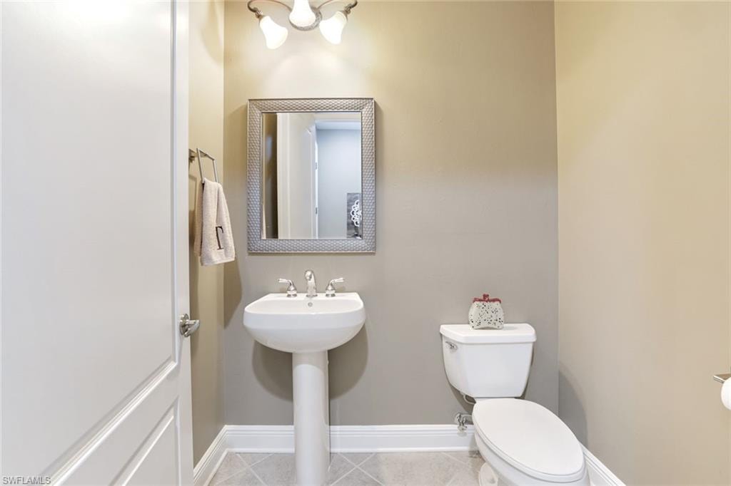 Bathroom with baseboards and tile patterned floors