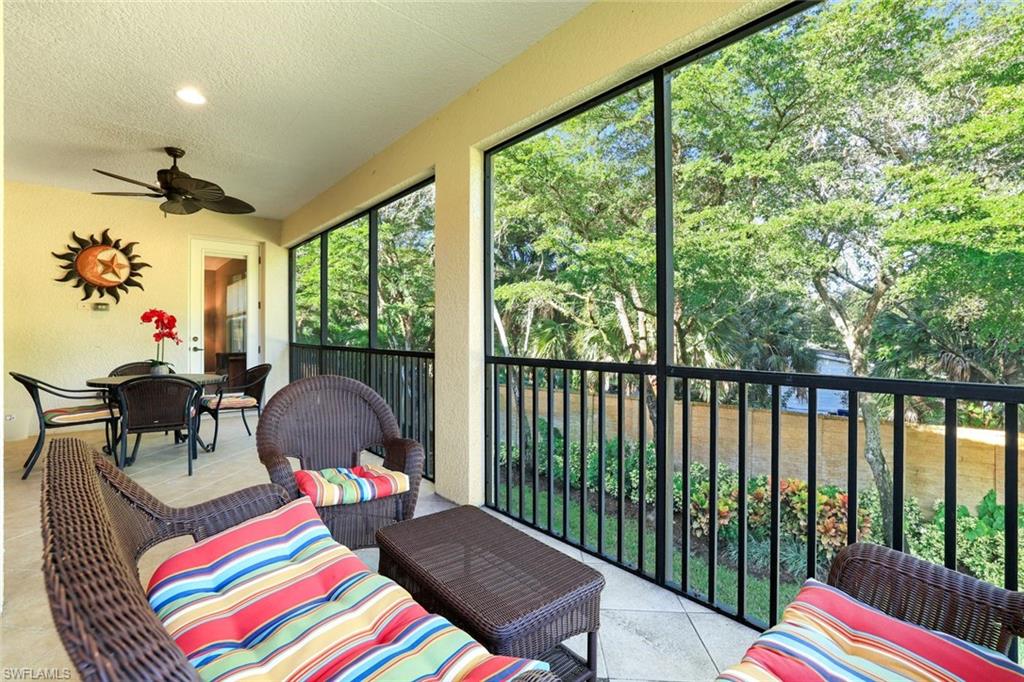 Sunroom / solarium featuring outdoor lounge area, a ceiling fan, outdoor dining space, and a water view