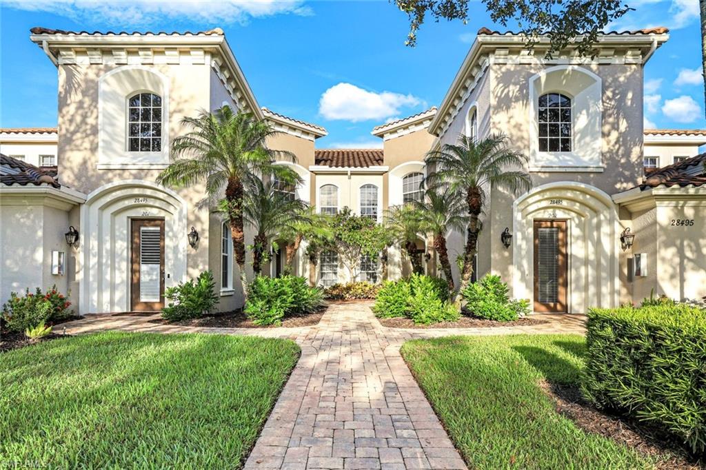 Mediterranean / spanish house featuring stucco siding, a front lawn, and a tiled roof