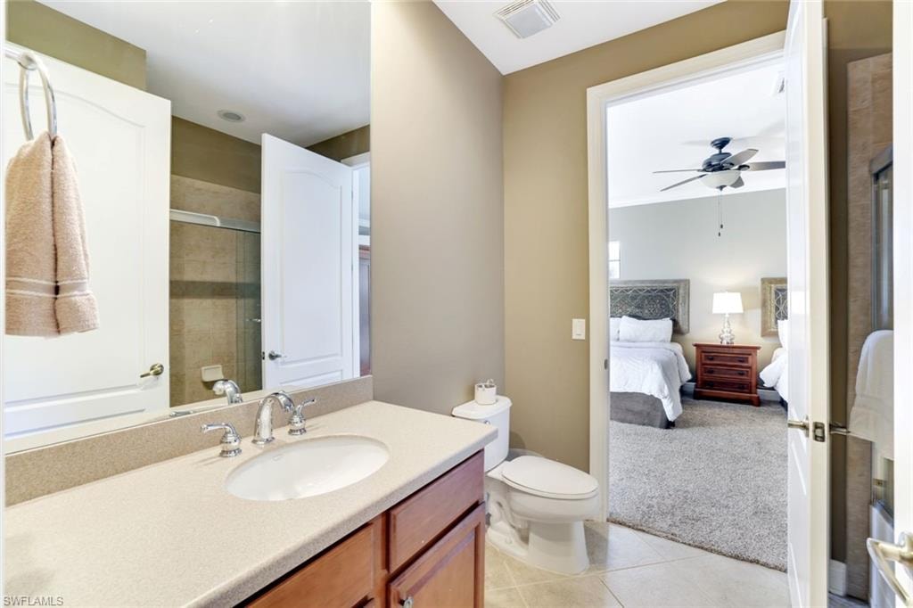 Full bath featuring ensuite bath, light colored carpet, vanity, light tile patterned flooring, and tiled shower