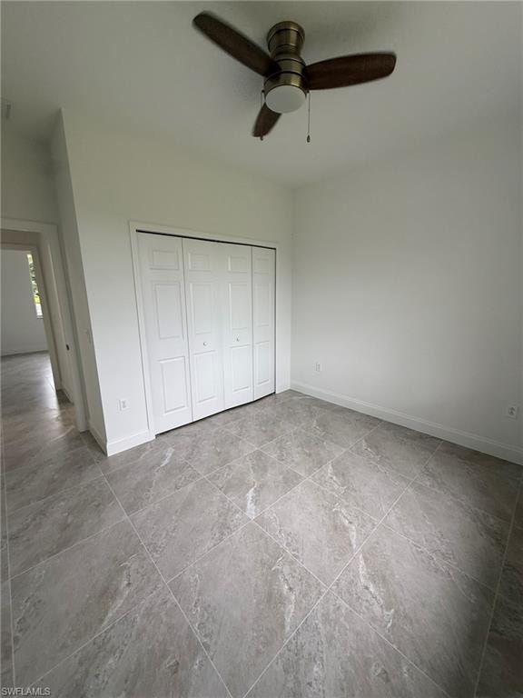 Unfurnished bedroom featuring a closet and ceiling fan