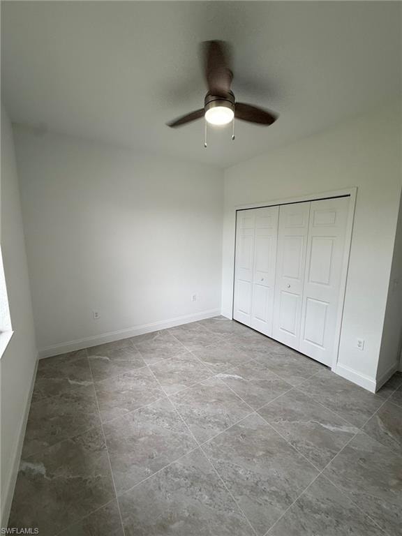 Unfurnished bedroom featuring a closet and ceiling fan