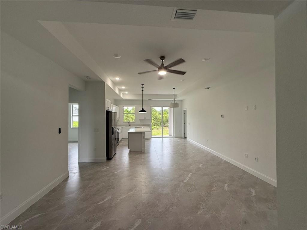 Unfurnished living room with recessed lighting and ceiling fan