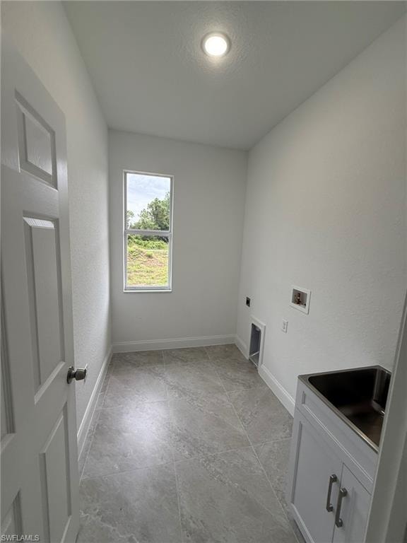 Laundry room featuring hookup for a washing machine, a textured wall, hookup for an electric dryer, and a textured ceiling