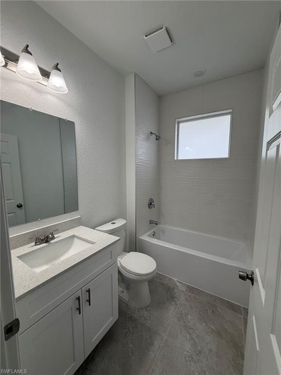 Bathroom with shower / washtub combination, vanity, and a textured wall