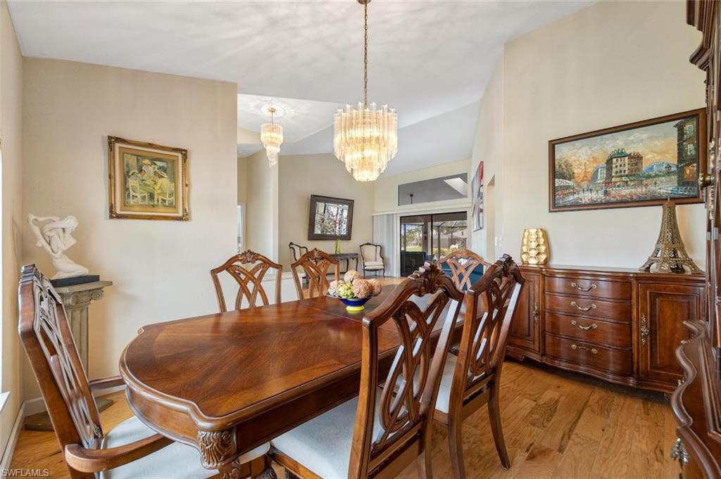 Dining area with wood finished floors and a chandelier