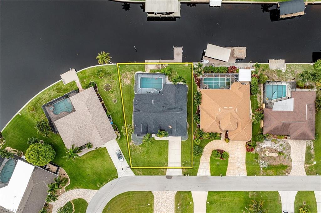 Aerial perspective of suburban area featuring property boundaries highlighted