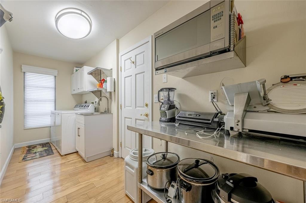 Laundry area with light wood finished floors and separate washer and dryer