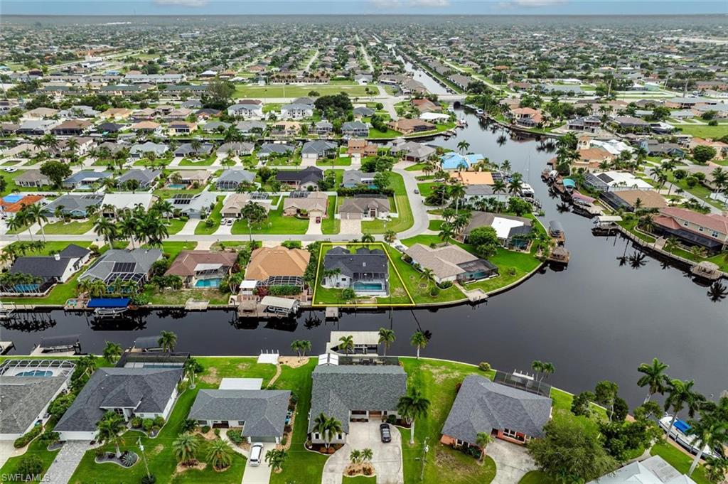 Aerial view of property and surrounding area with nearby suburban area and a nearby body of water
