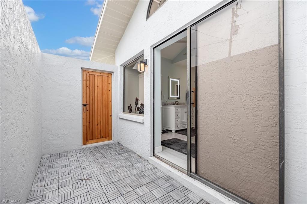 Property entrance featuring stucco siding