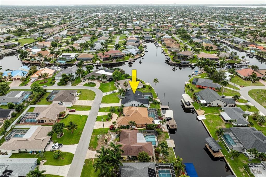 Aerial view of property's location with nearby suburban area
