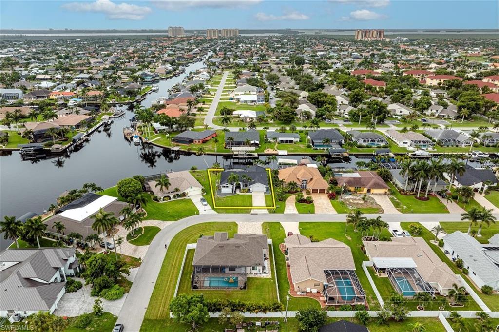 Aerial overview of property's location featuring nearby suburban area and a large body of water