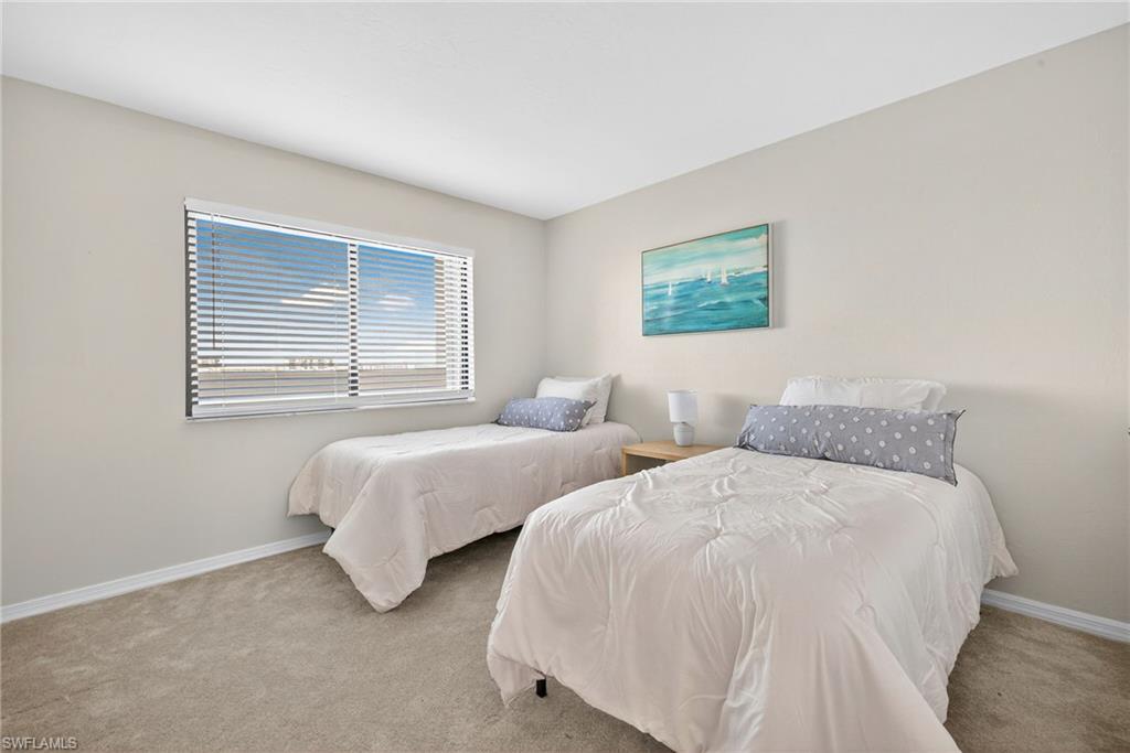 Carpeted bedroom with baseboards