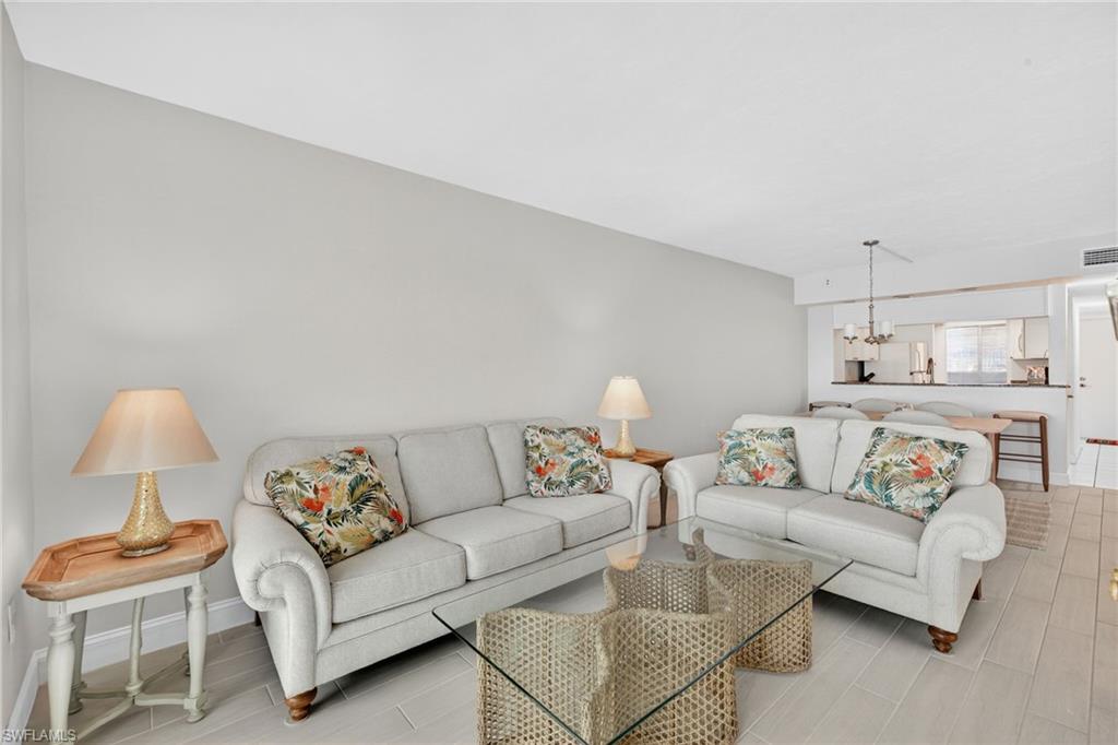 Living room featuring a chandelier and wood finish floors