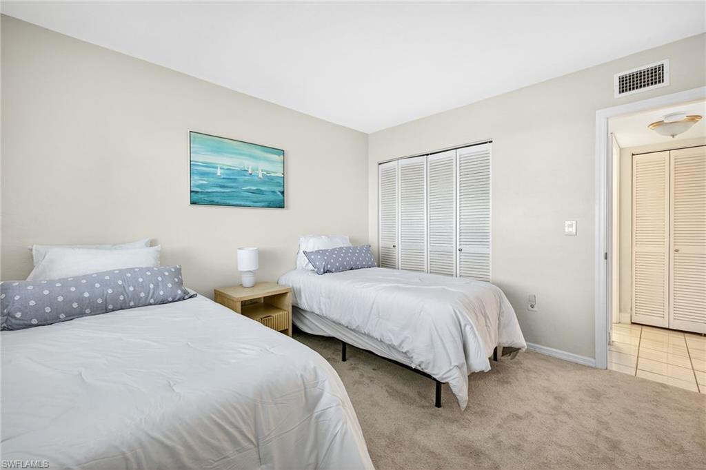 Carpeted bedroom featuring baseboards and a closet
