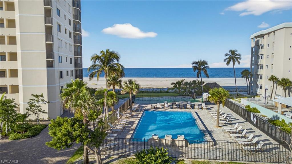 Community pool with a patio and a water view