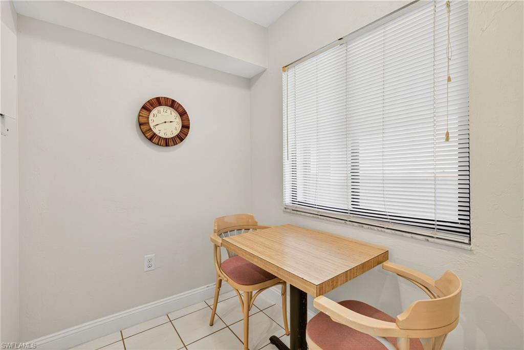 Dining space featuring light tile patterned floors and baseboards