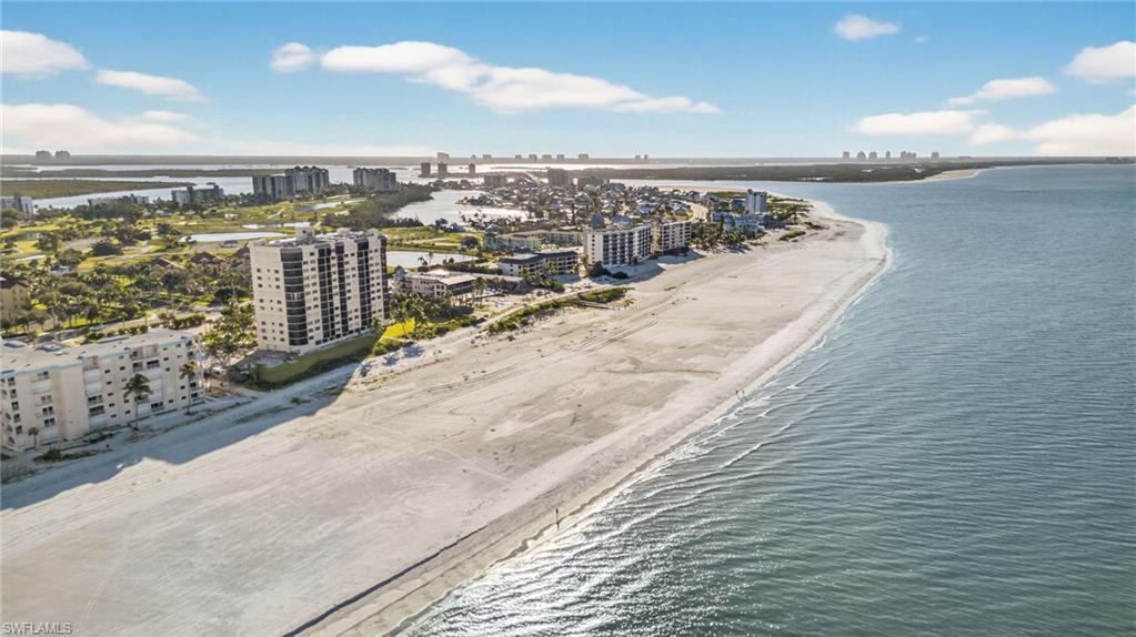 View of urban area featuring waterfront with a beach