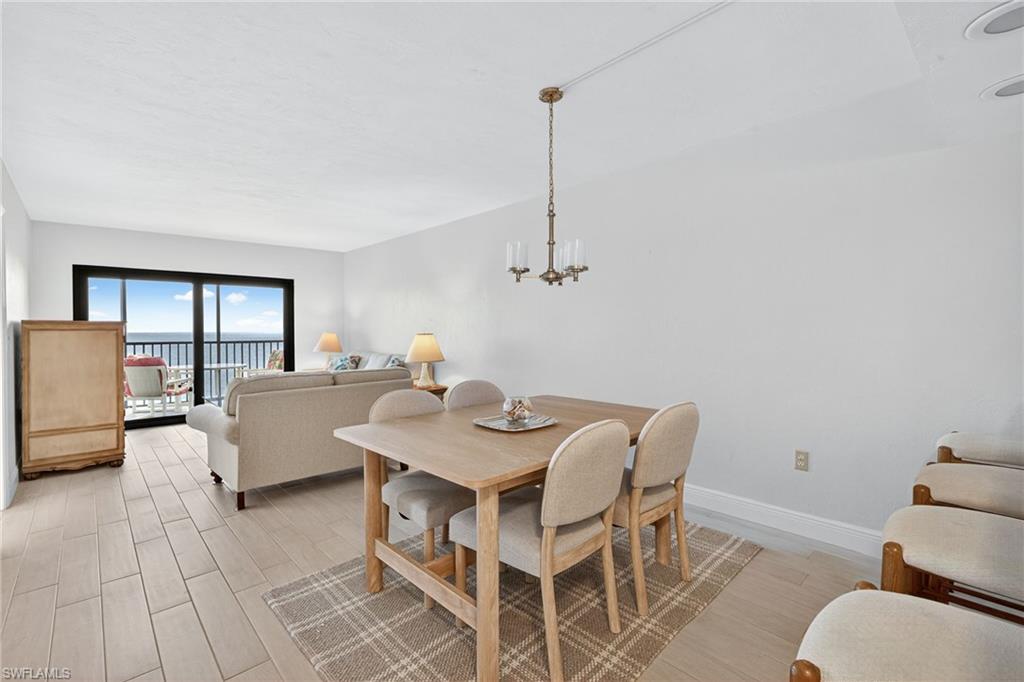 Dining space featuring light wood-style flooring and baseboards