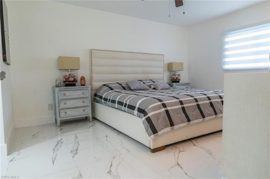Bedroom featuring porcelain finish floors and ceiling fan