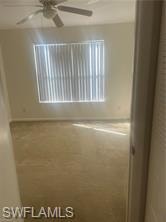 Unfurnished bedroom with a spacious closet and baseboards