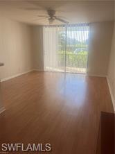 Empty room with ceiling fan and wood finished floors