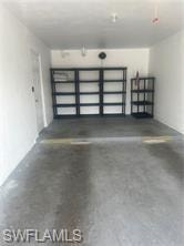 Corridor with wood finished floors and baseboards