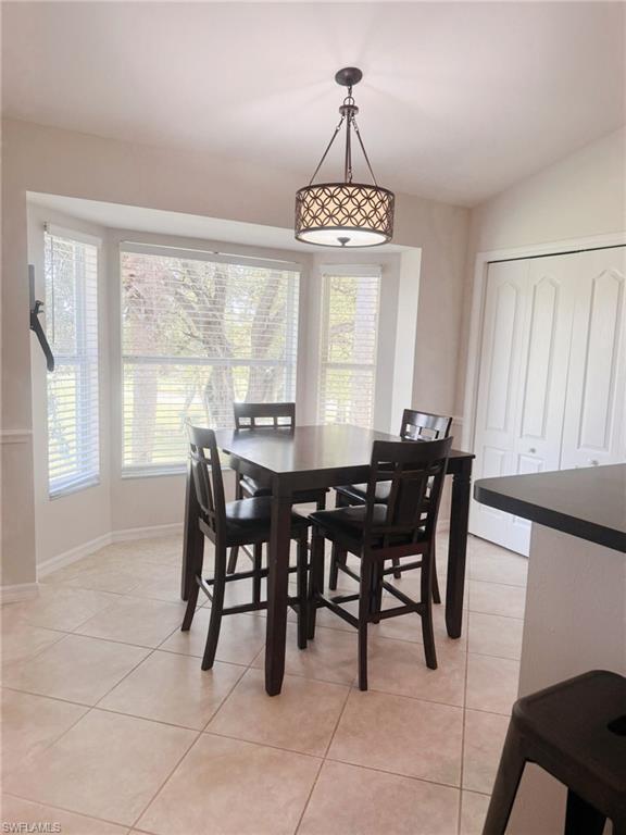 Dining space featuring light tile patterned flooring and healthy amount of natural light