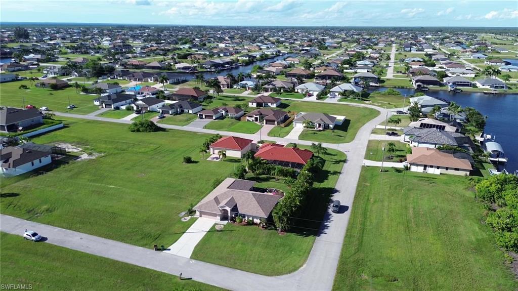 View of property location with a nearby body of water and nearby suburban area