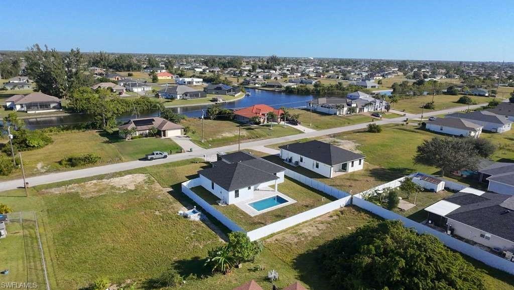 Aerial view of residential area featuring a nearby body of water