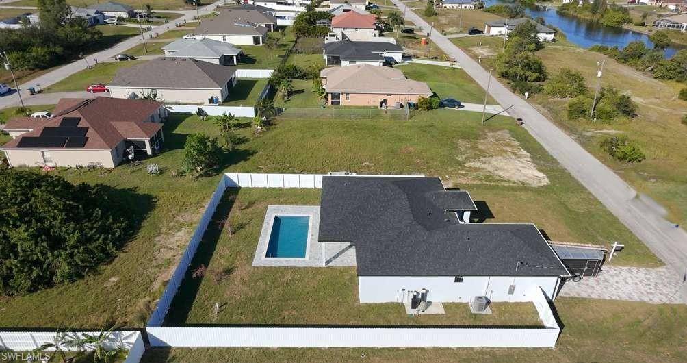 Aerial perspective of suburban area with a pool area