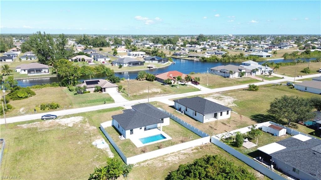 Aerial perspective of suburban area with a nearby body of water