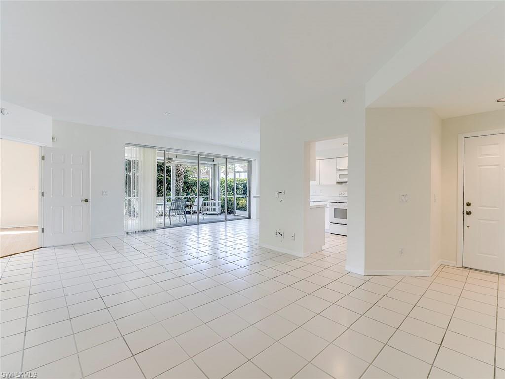 Room featuring light tile patterned floors and baseboards
