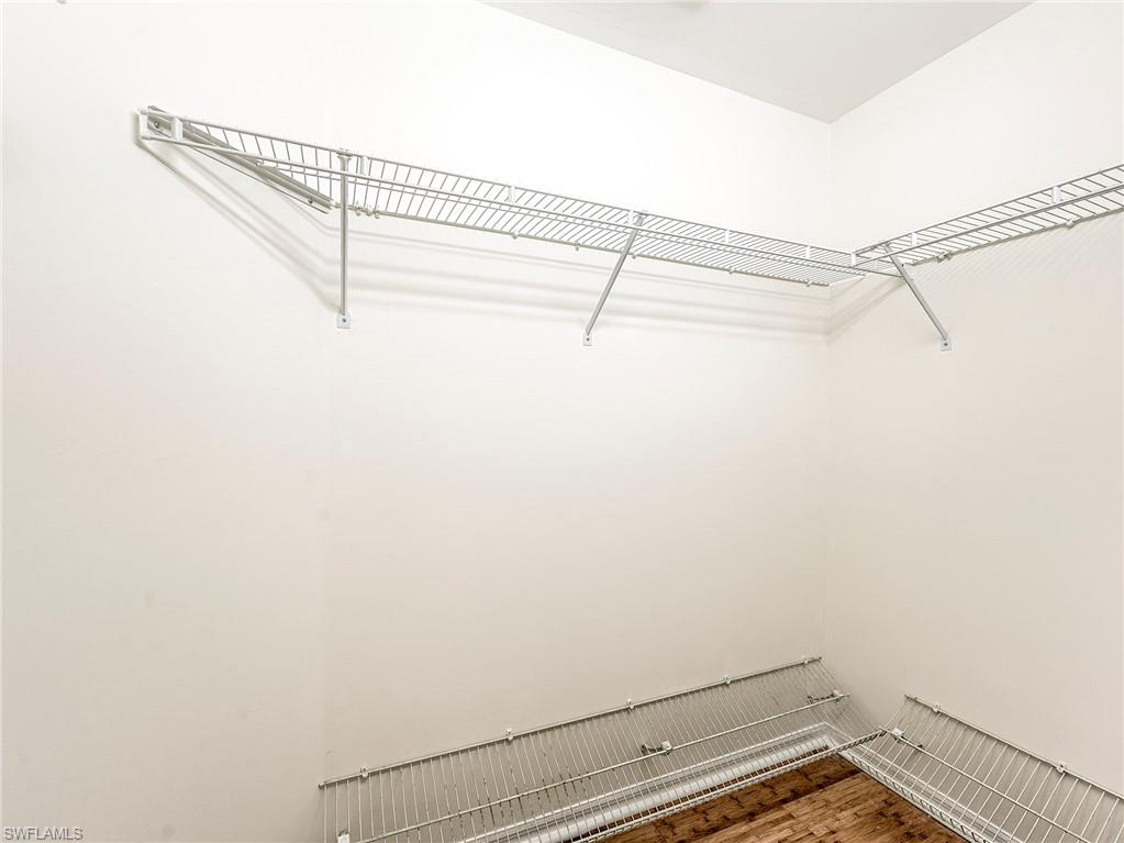 Walk in closet featuring wood finished floors
