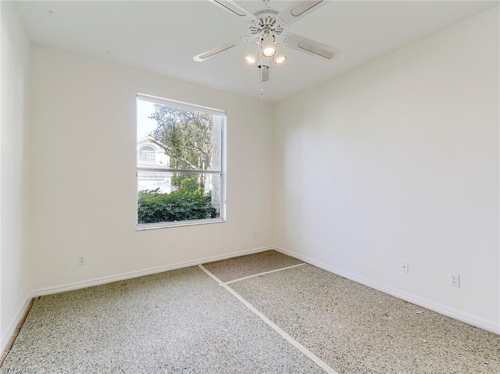 Spare room featuring ceiling fan and speckle patterned floor