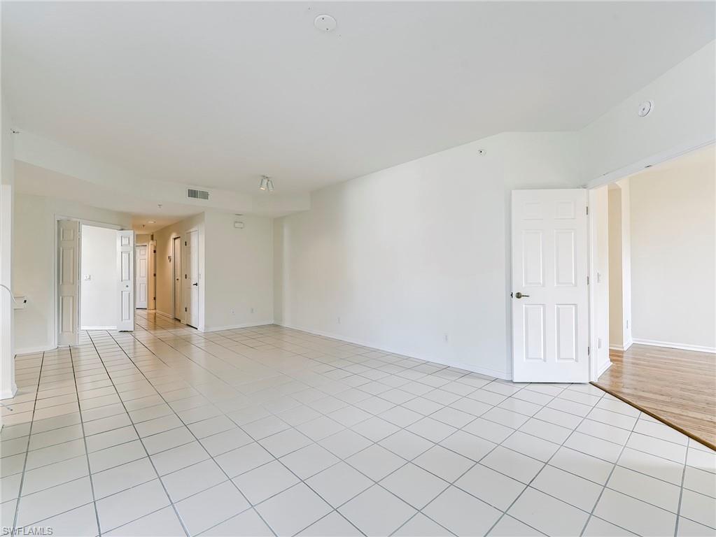 Room with light tile patterned flooring and baseboards