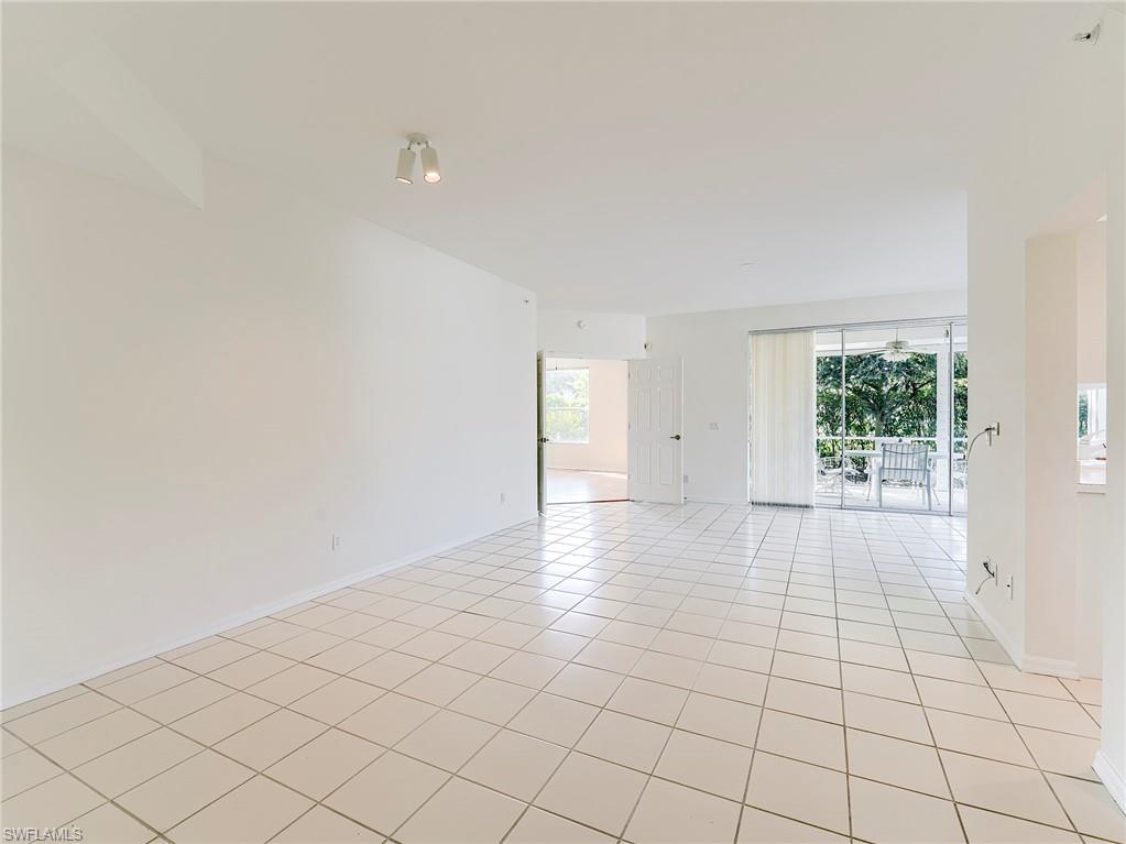 Room featuring light tile patterned floors and baseboards