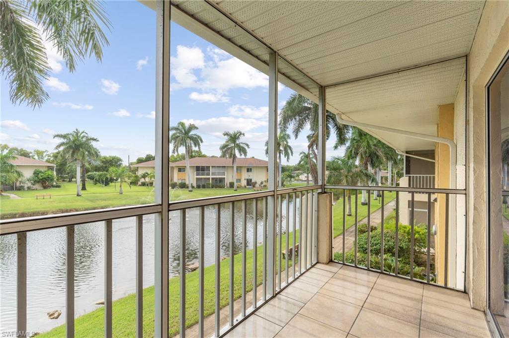Balcony with a water view and a sunroom