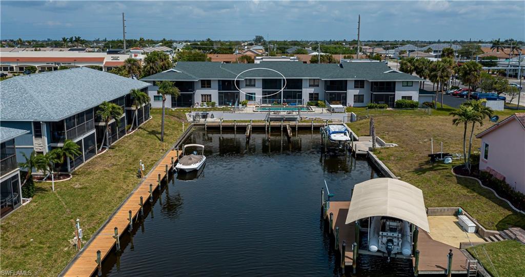 Aerial perspective of suburban area featuring a nearby body of water