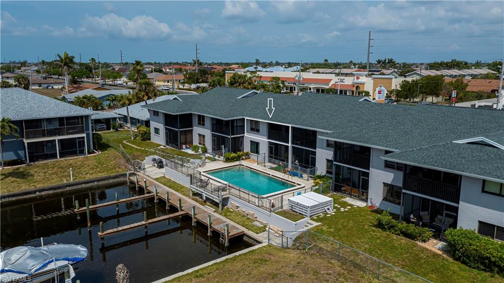Aerial view of residential area featuring a pool area