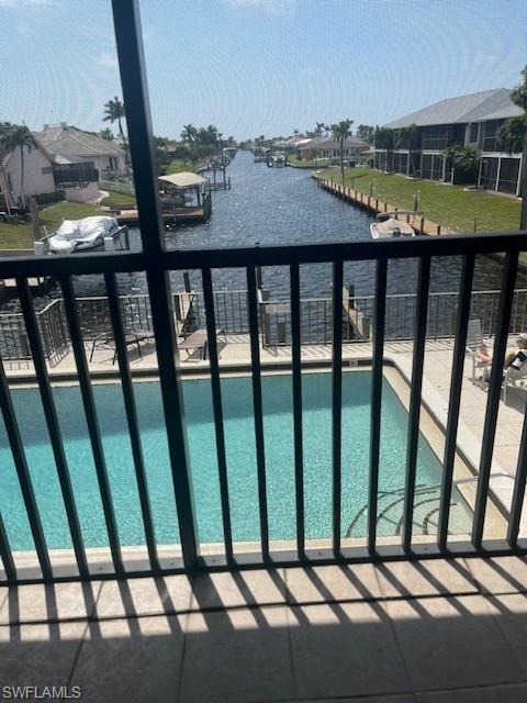 Community pool with a balcony and a water view