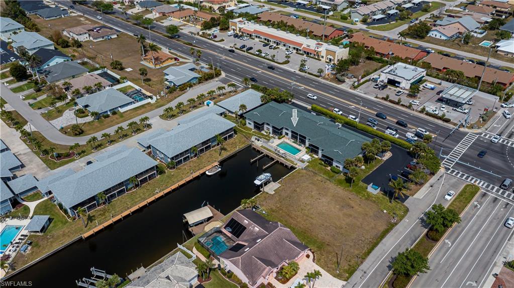 Aerial view of property and surrounding area featuring nearby suburban area