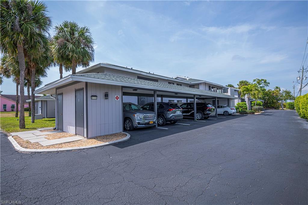 View of building exterior with covered parking