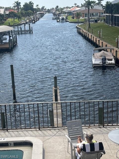 Dock area with a water view and a residential view