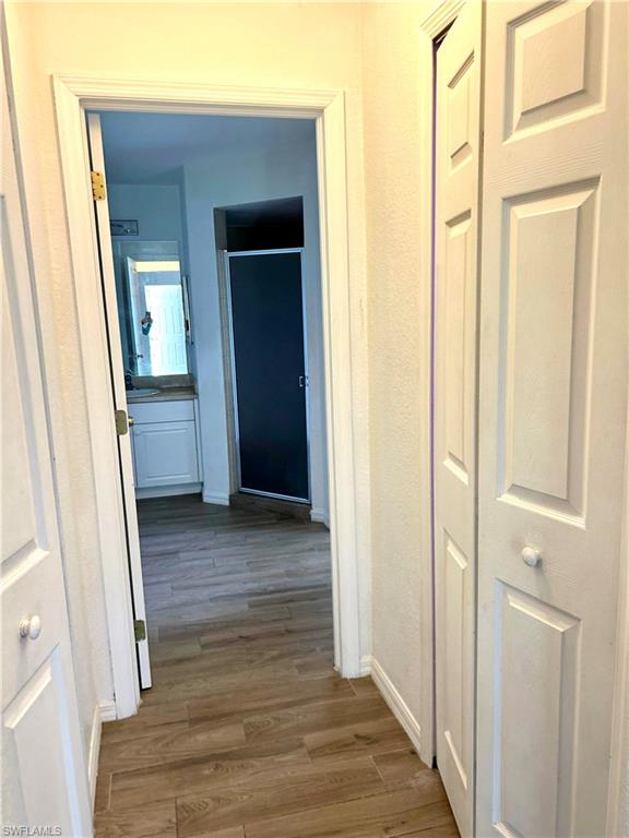 Spare room with light wood finished floors and a ceiling fan