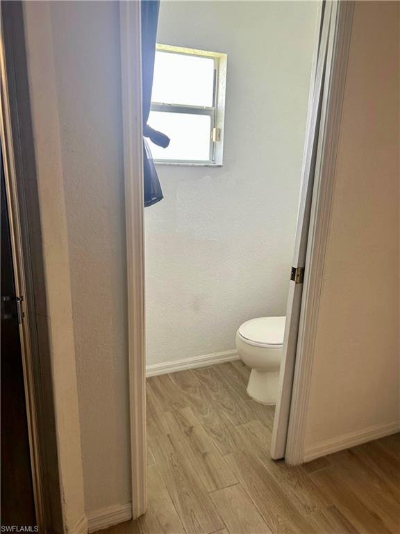 Spacious closet with dark wood-style flooring