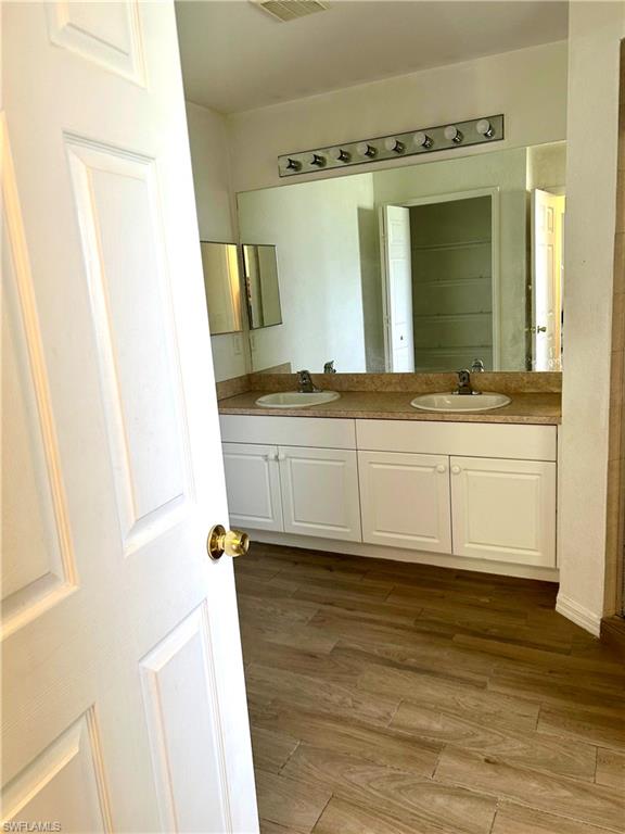 Unfurnished room with light wood-style floors, a ceiling fan, and a textured ceiling