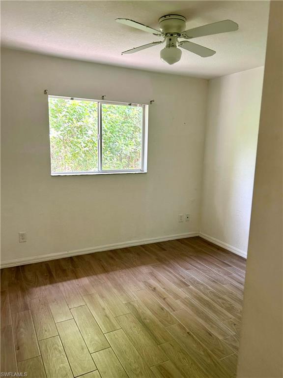 Laundry room with wood finish floors and washer and clothes dryer