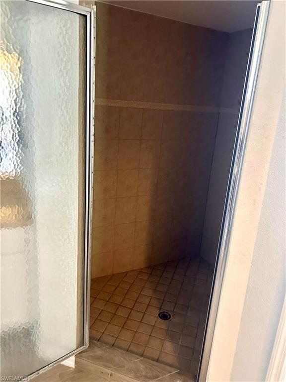Bathroom with light wood finished floors and a textured wall