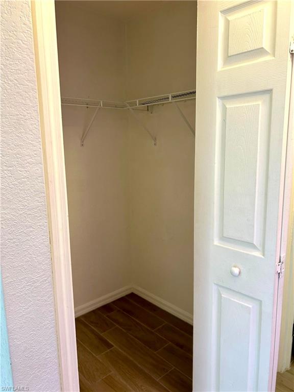 Corridor featuring light wood-style floors and baseboards